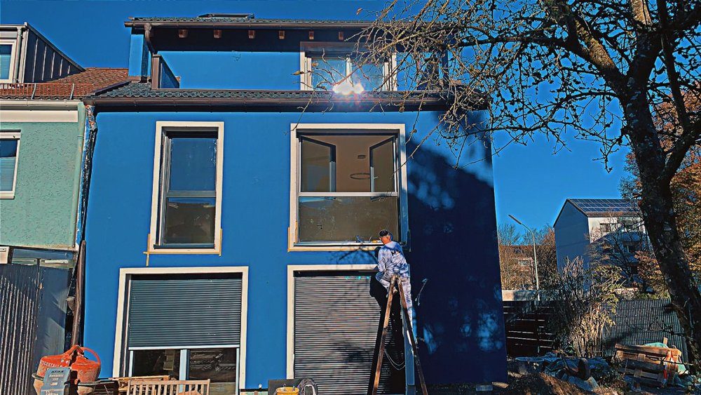 MEL-Mitarbeiter an einer blauen Fassade